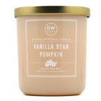 A DW Home Vanilla Bean Pumpkin scented candle in a matte beige jar with a metallic gold lid and a white label.