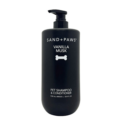 Black bottle of Sand + Paws Vanilla Musk pet shampoo and conditioner on a white background