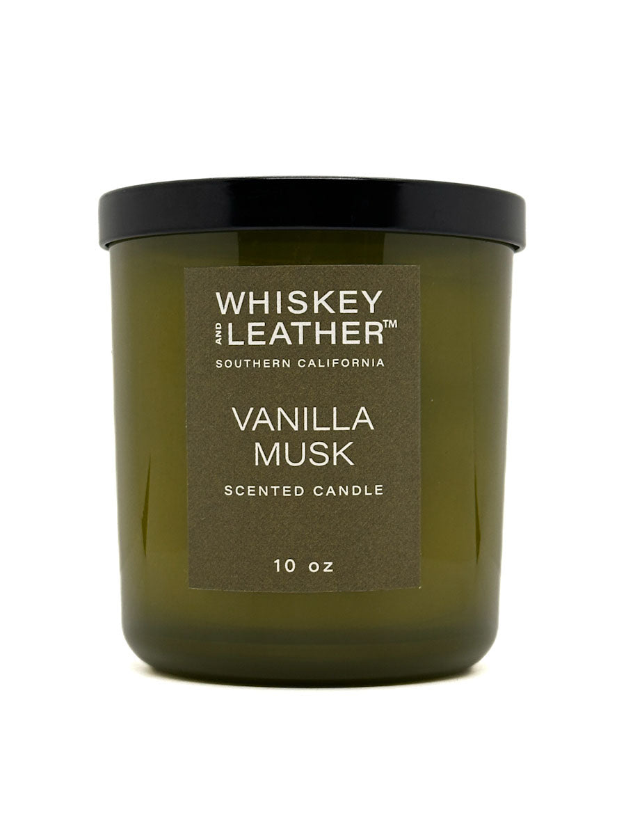 Green candle with a black lid labeled 'Whiskey and Leather Vanilla Musk' on a white background