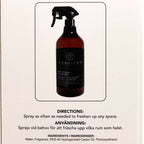 Brown spray bottle with black label on a beige background