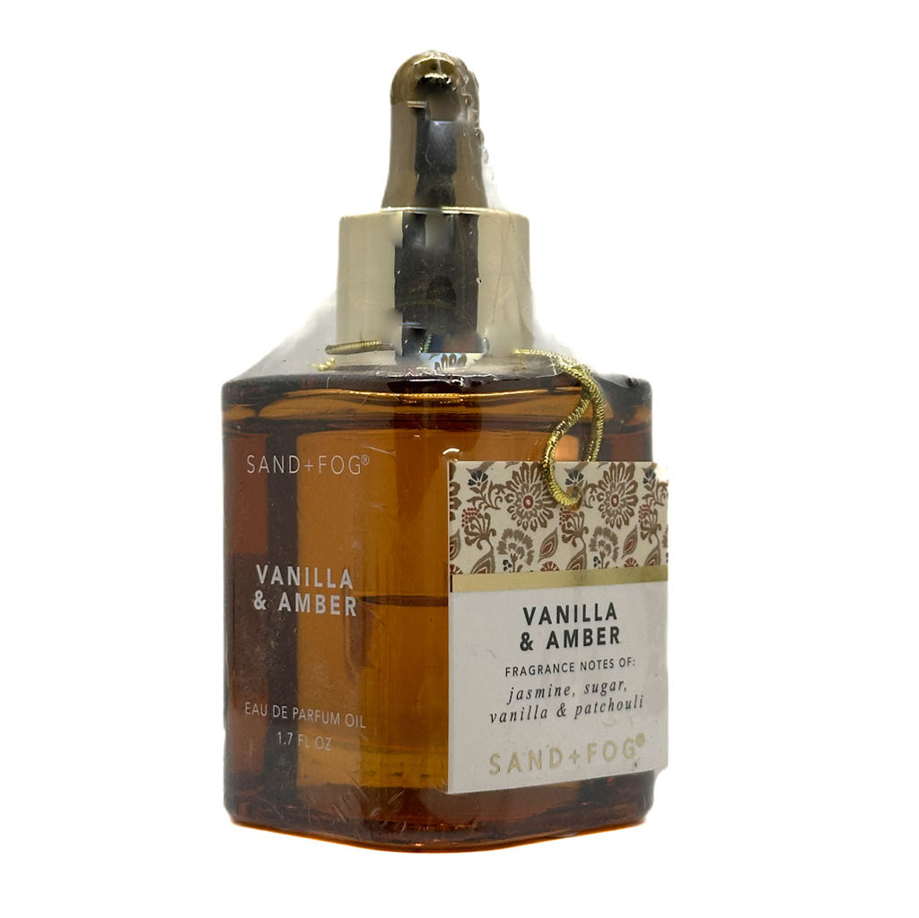 Perfume oil bottle labeled 'Vanilla & Amber' by Sand + Fog on a white background