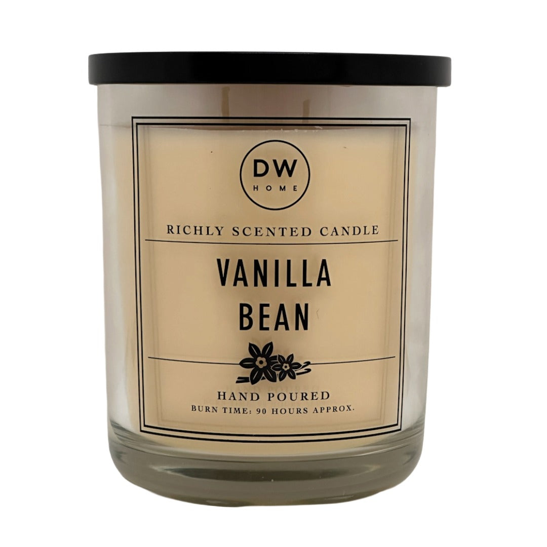 A DW Home 744g Vanilla Bean scented candle in a clear glass jar with a black lid and a cream-coloured label, shown against a plain white background.