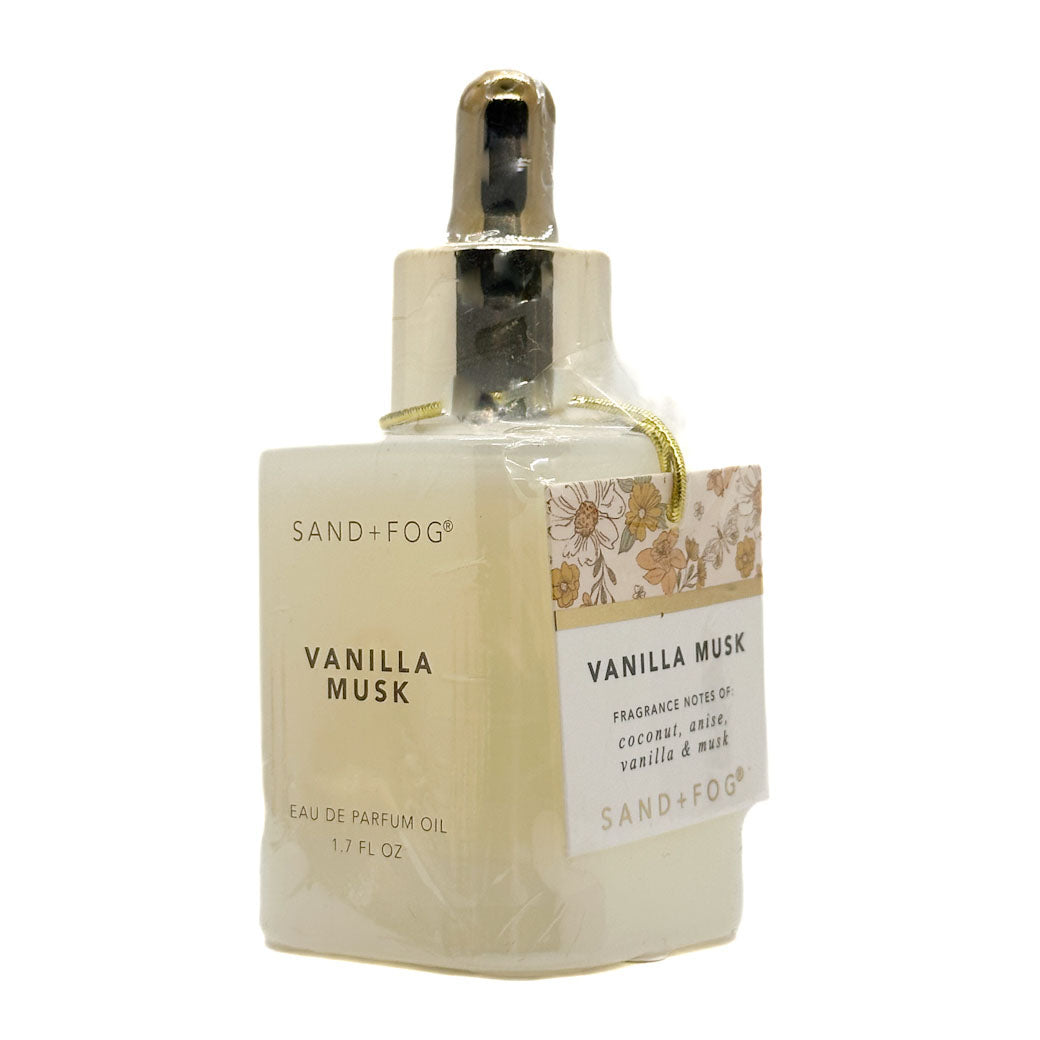 Vanilla Musk perfume oil bottle with floral label on a white background