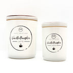Two white ceramic candles with matching lids, labeled 'Vanilla Pumpkin Latte' by Cafe Creations, on a clean white background.