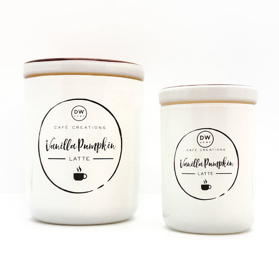 Two white ceramic candles with matching lids, labeled 'Vanilla Pumpkin Latte' by Cafe Creations, on a clean white background.