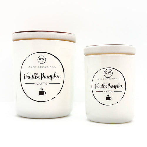Two white ceramic candles with matching lids, labeled 'Vanilla Pumpkin Latte' by Cafe Creations, on a clean white background.