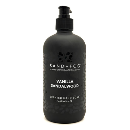A matte black pump bottle of Sand + Fog Vanilla Sandalwood scented hand soap on a clean white background.