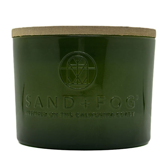 Velvet Pear green candle jar with 'Sand + Fog' branding on a white background
