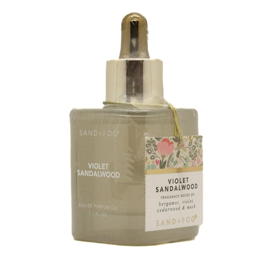 SAND + FOG Sandalwood eau de parfum oil with floral label on a white background + FOG 