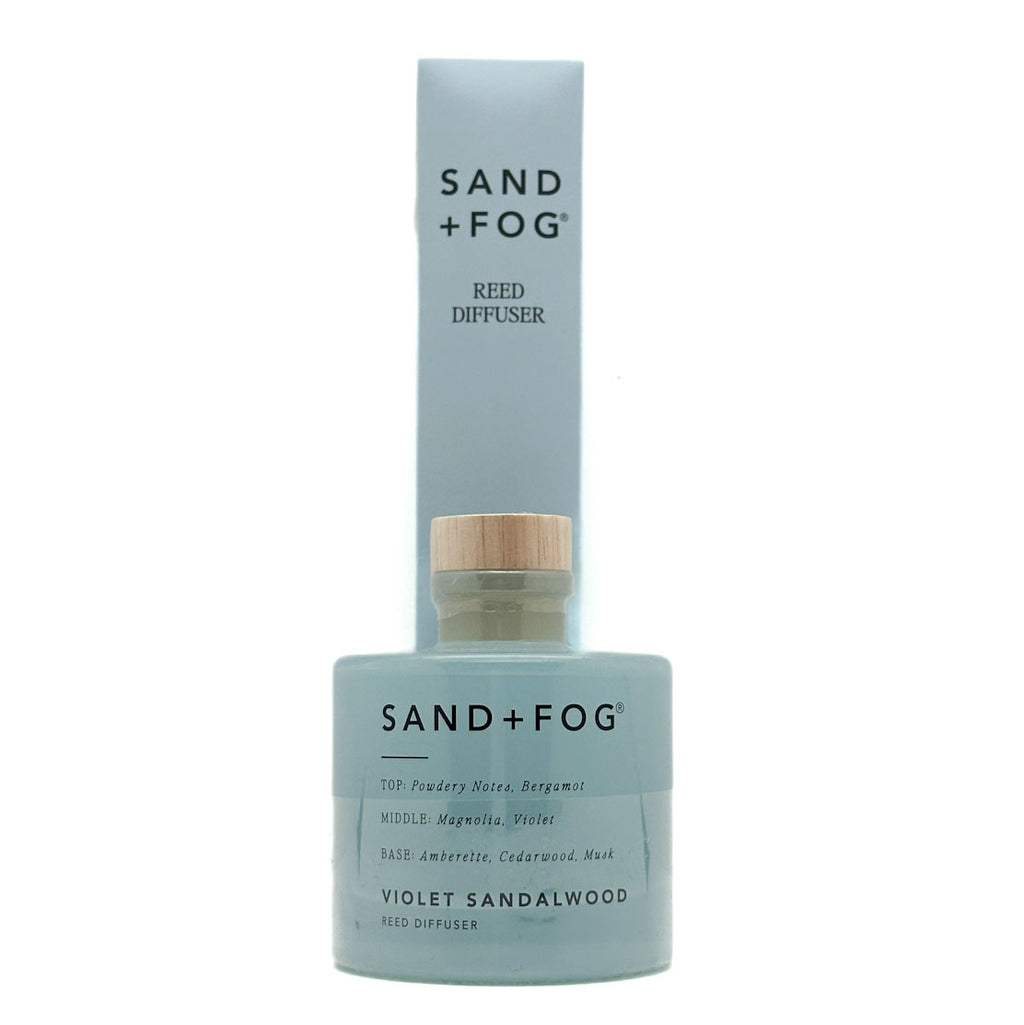 Sand + Fog Violet Sandalwood reed diffuser with blue bottle and white label on a white background