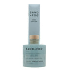 Sand + Fog Violet Sandalwood reed diffuser with blue bottle and white label on a white background