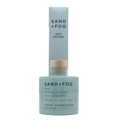 Sand + Fog Violet Sandalwood reed diffuser with blue bottle and white label on a white background