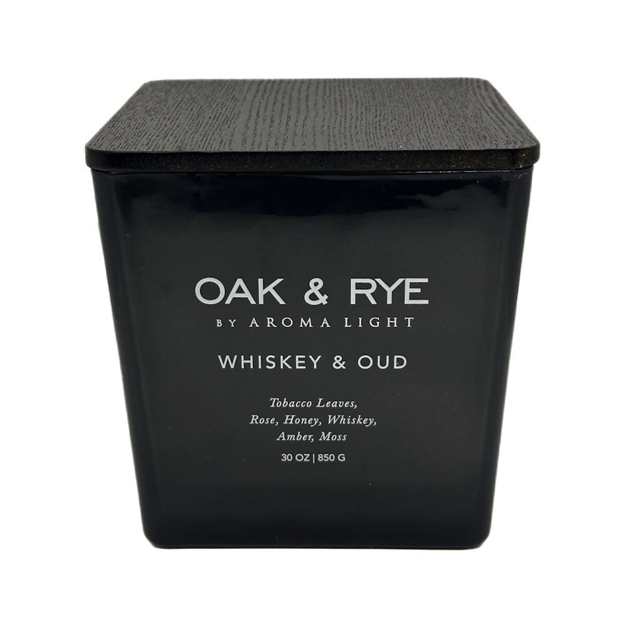 Black candle container with 'Oak & Rye' branding and description on a white background