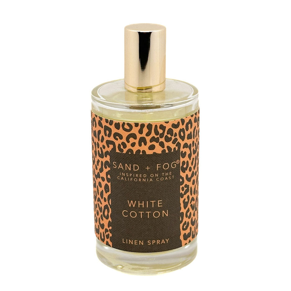 Bottle of Sand + Fog White Cotton linen spray with leopard print label on a white background