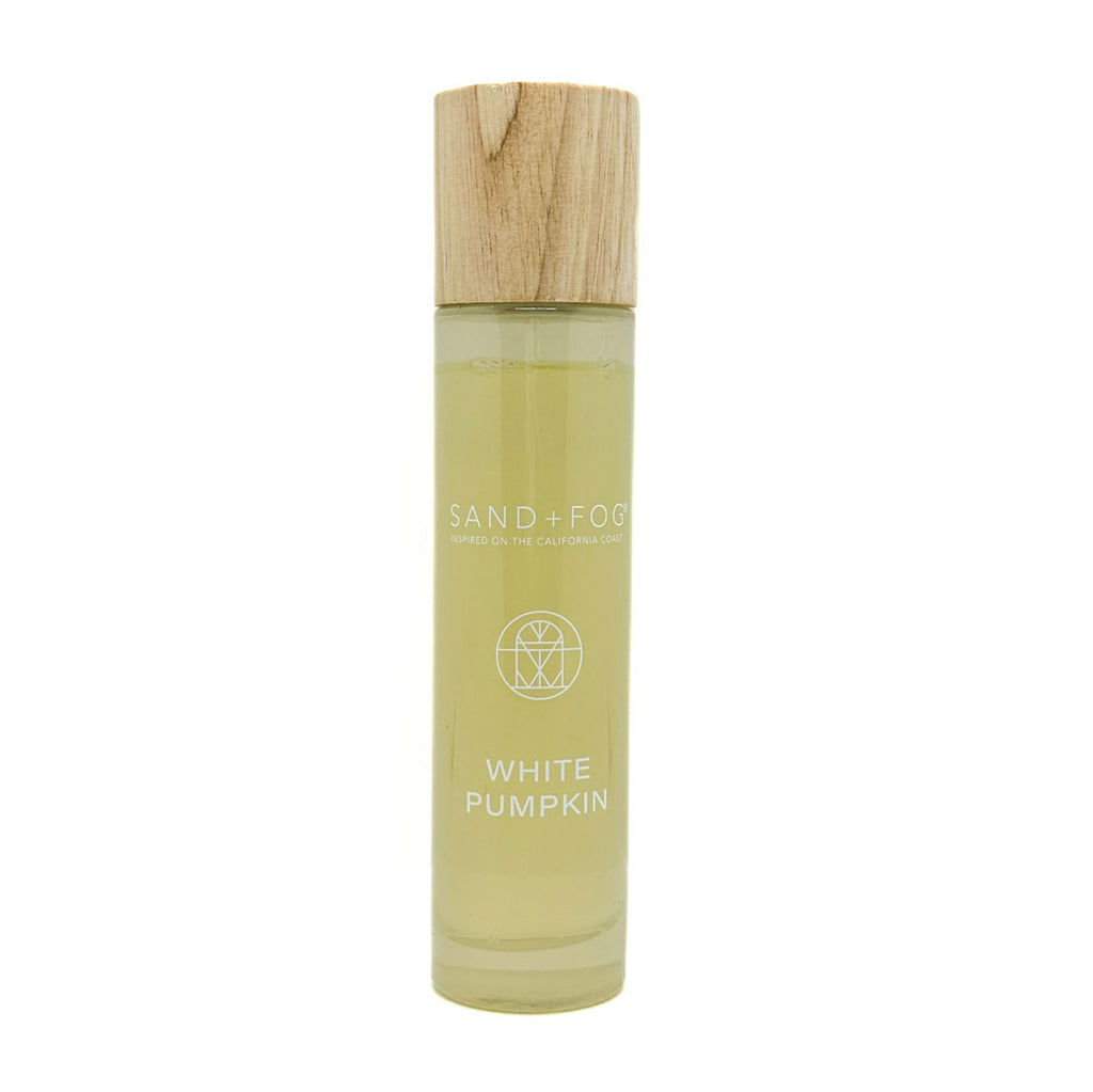 SAND + FOG room spray bottle labeled 'White Pumpkin' with a wooden cap on a white background