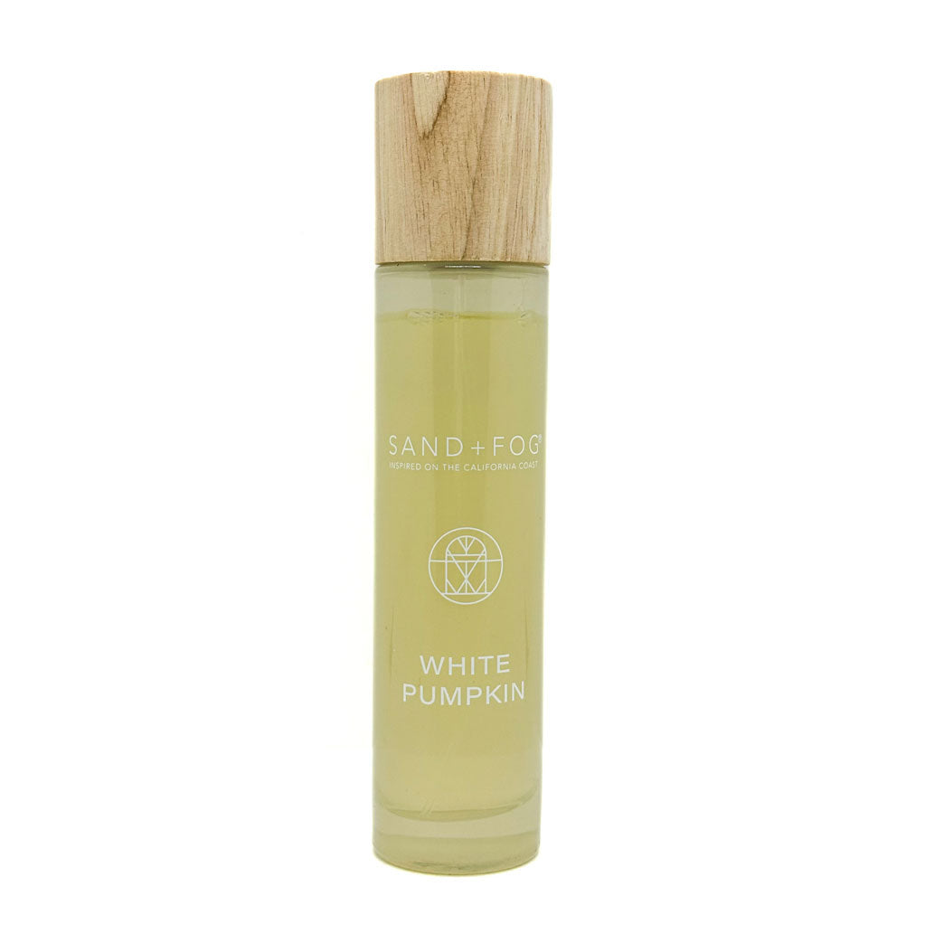 SAND + FOG room spray bottle labeled 'White Pumpkin' with a wooden cap on a white background