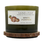 Green candle with a label for 'White Pumpkin' by Sand + Fog on a white background