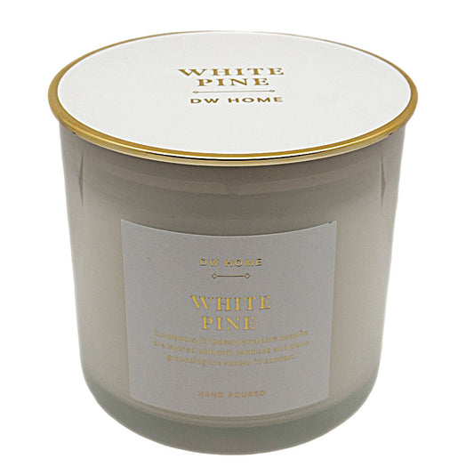 A DW Home White Pine scented candle in a frosted glass jar with a white lid and gold trim, featuring a white label with gold lettering.