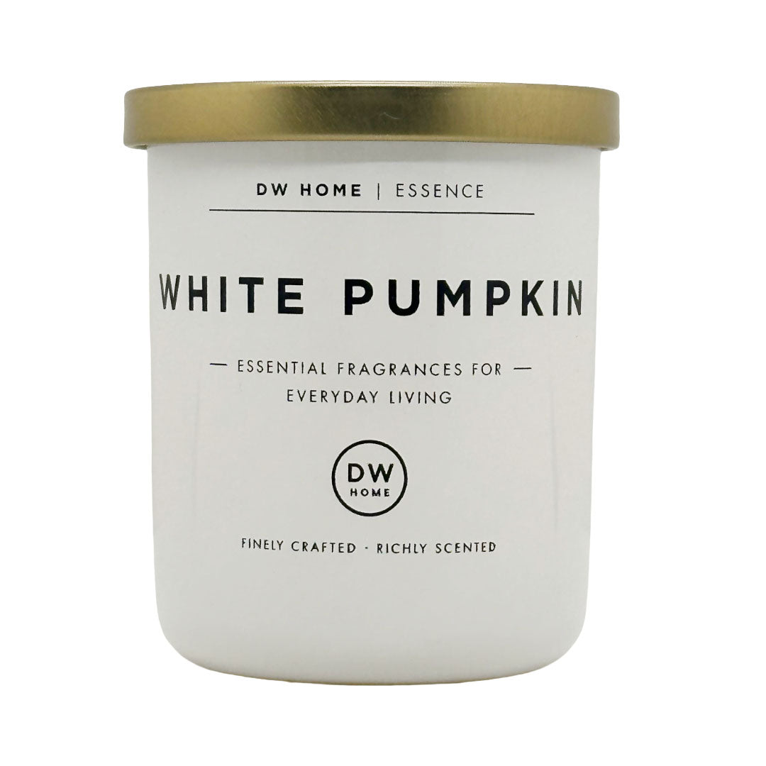 A white scented candle jar with a metallic gold lid, labeled 'WHITE PUMPKIN' by DW HOME | ESSENCE, on a plain white background.
