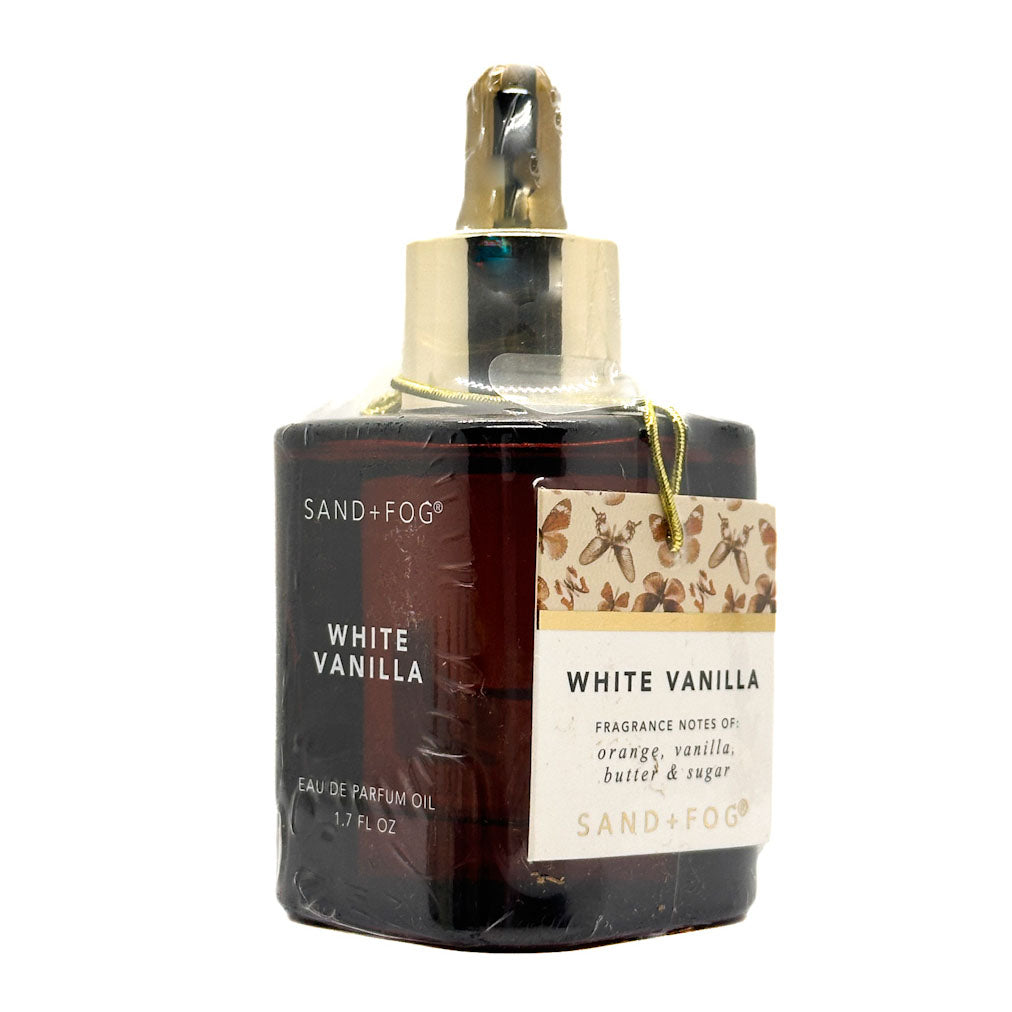 Perfume oil bottle labeled 'White Vanilla' by Sand + Fog on a white background