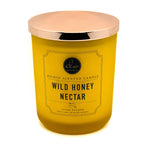 DW Home yellow candle with a rose gold lid labeled 'Wild Honey Nectar' on a white background