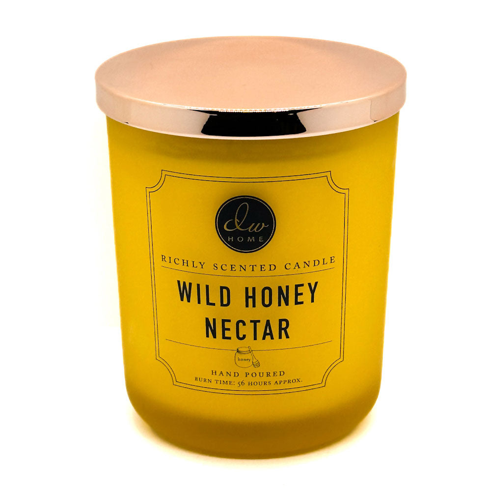 DW Home yellow candle with a rose gold lid labeled 'Wild Honey Nectar' on a white background