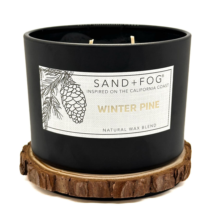 BlackWinter Pine candle with 'Sand + Fog' label on a white background