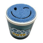 Blue candle by DW HOME with smiley face on lid and 'You're Cute' text on a white background